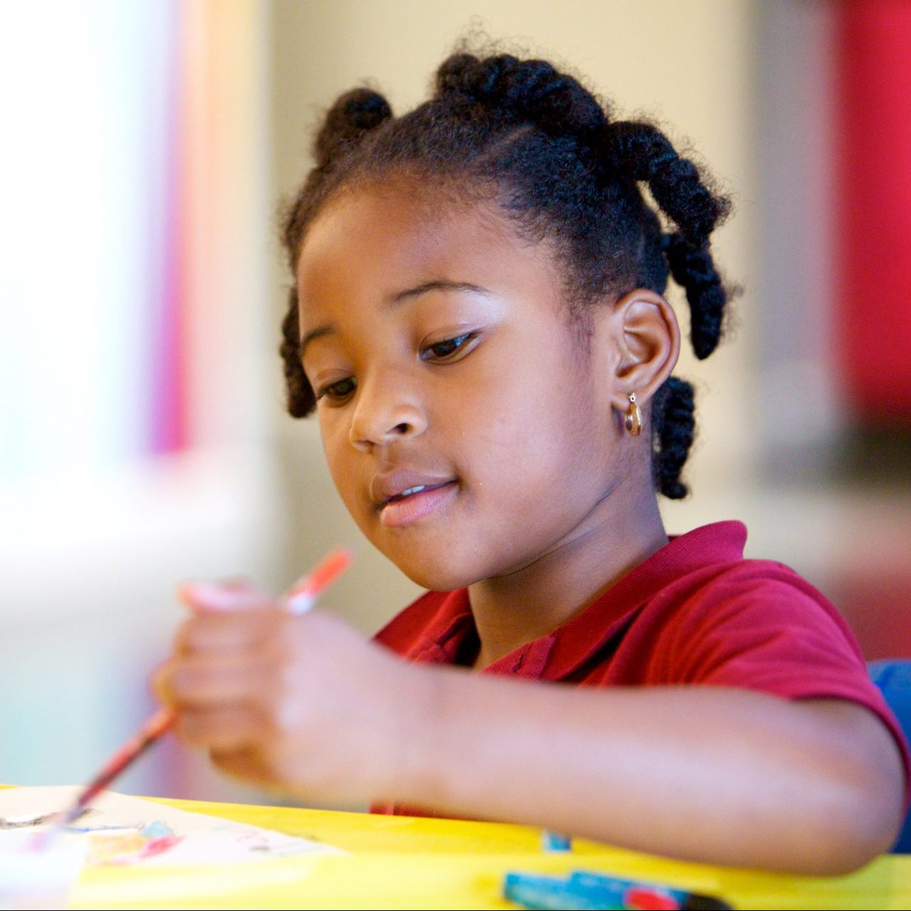 a child drawing with pencil at School for kids in Maryland