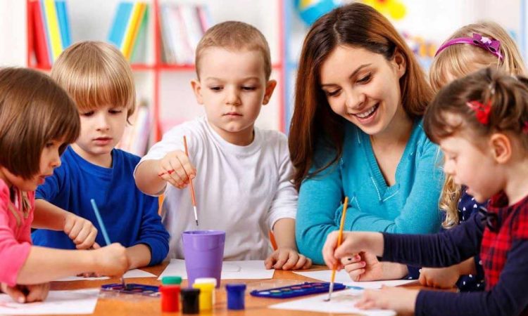 5 children doing painting in class together